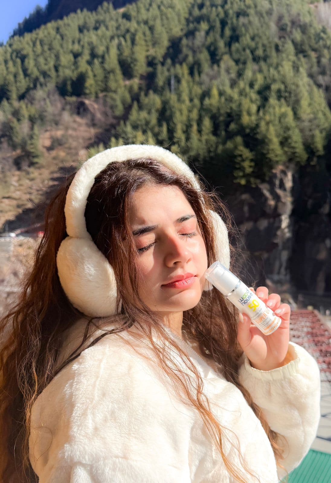 Wood House Super UV sunscreen in use against a Himalayan pine forest